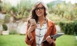 Portrait of a smiling woman holding mobile phone